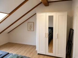 a room with a white cabinet in the attic at Heyne-Ufer City Apartment II - TOP Innenstadtlage in Göttingen