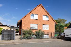 a brick house with a fence in front of it at Veith in Hildesheim