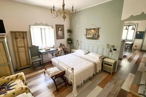 a bedroom with a bed and a table and a couch at Antico Leccio Green in Coppe