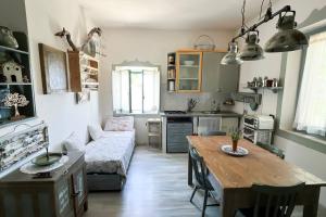 a living room with a table and a couch at Antico Leccio Green in Coppe