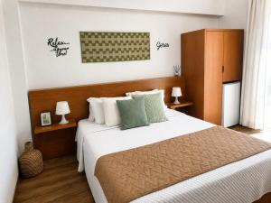 a bedroom with a large bed with white and green pillows at Verde Pinho in Geres +66 photos