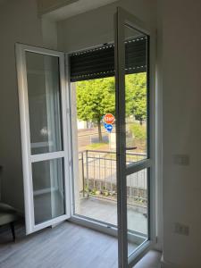 an open sliding glass door with a stop sign at Casa Vacanza Giorgio Apartment in Gallarate