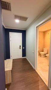 an empty room with a toilet and a door at Bricks Hotel in Tbilisi City +291 photos