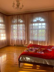 a bedroom with a bed in front of a window at Heritage Garden Villa by Eldar in Ganja