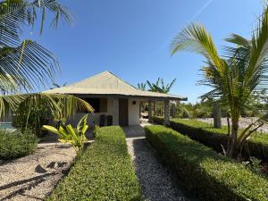 a house on the beach with palm trees at Toubakouta River Paradise in Toubakouta