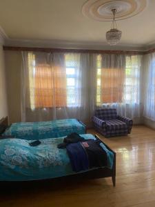 a bedroom with a bed and a couch at Heritage Garden Villa by Eldar in Ganja +14 photos