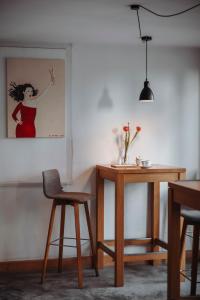 a room with a table and a chair and a painting at Josis Klause Café I Pension in Albstadt