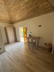 a room with a table and a wooden floor at Toubakouta River Paradise in Toubakouta