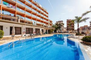 a large swimming pool in front of a building at Hotel Bon Repos in Calella +83 photos