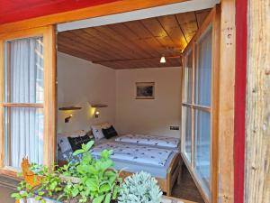 a bedroom with a bed and a balcony at Haus Wimbachtal in Ramsau