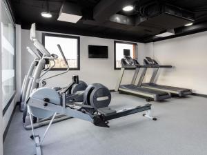 a gym with three tread machines in a room at ibis Madrid Norte Las Tablas in Madrid