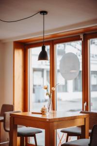 a dining room table with a vase of flowers on it at Josis Klause Café I Pension in Albstadt