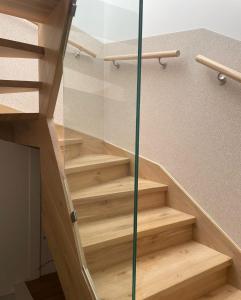 a staircase in a house with a glass wall at Rooms Brussels Airport- 'The Good Place' in Zaventem