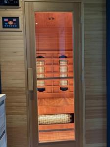 a glass door of a kitchen with lights in it at Wellnesslodge Specht jacuzzi and sauna and privacy in Dalerveen