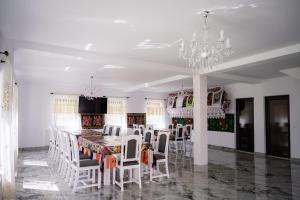 a dining room with a table and chairs and a chandelier at Breb 155 in Breb