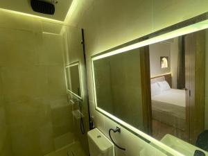 a bathroom with a mirror and a sink and a bed at Latina City in Cairo +30 photos