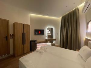 a hotel room with a bed and a tv at Latina City in Cairo