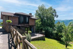 a house with a wooden fence in front of it at Fidalsa Paradise Point in Cabezón de Liébana
