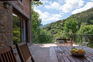 a patio with a table with a bowl of fruit at Fidalsa Paradise Point in Cabezón de Liébana +80 photos