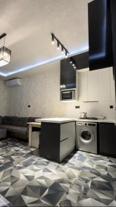a kitchen with a sink and a dishwasher at Palm Villa in Mərdəkan