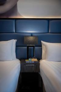 a room with two beds and a table with a lamp at The Residence Hotel in Galway +23 photos