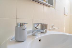 a bathroom sink with a faucet on top of it at Piazza Michele Ferrero - sulla piazza centrale in Alba +37 photos