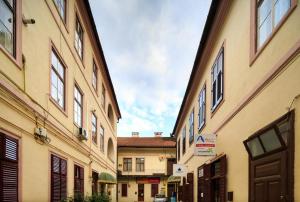 an alley between two buildings in a city at Central Square Studios in Sibiu