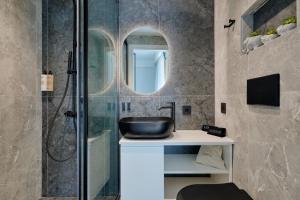 a bathroom with a sink and a mirror at Agia Triada Suites in Heraklio +67 photos