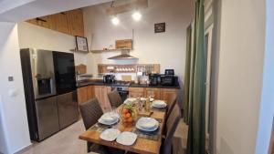 a kitchen with a wooden table with plates on it at 4Rest Villa in Novalja