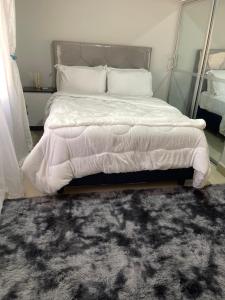 a bedroom with a large bed with a rug at Elimisam stays in Kitwe