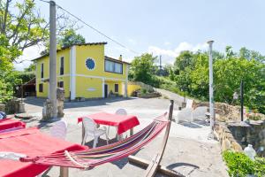 a patio with a table and chairs and a house at Casale Rustico ColleBello in Castiglione Messer Raimondo