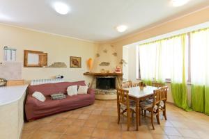 a living room with a couch and a table at Casale Rustico ColleBello in Castiglione Messer Raimondo