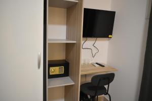 a room with a desk with a tv and a chair at Hotel Boutique Traveler 360 in Madrid