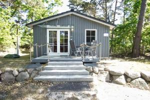 a tiny house with a porch and a patio at Chalet Ostsee Nr 72 in Göhren