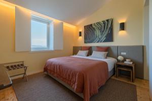a bedroom with a large bed and a window at Casas da Quinta de Santa Cruz - Douro Land in Peso da Régua +42 photos