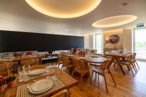 a dining room with wooden tables and chairs at Casas da Quinta de Santa Cruz - Douro Land in Peso da Régua