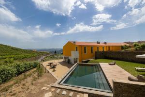 a backyard with a swimming pool and a house at Casas da Quinta de Santa Cruz - Douro Land in Peso da Régua