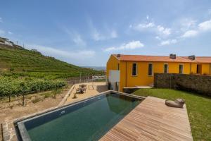 a backyard with a swimming pool and a house at Casas da Quinta de Santa Cruz - Douro Land in Peso da Régua