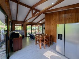 a kitchen with a refrigerator and a table in a room at House in Playa Carrillo-Samara in Arbolito