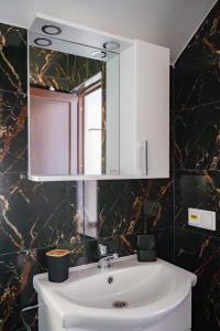 a bathroom with a white sink and a mirror at Breb 155 in Breb +23 photos