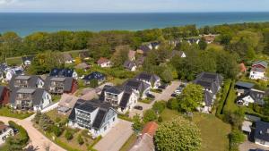 an aerial view of a town with houses and the ocean at Dünenquartier Apartment 24 in Zingst