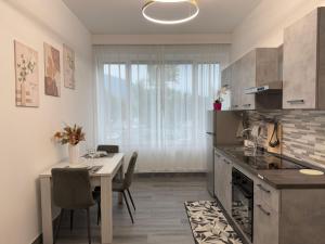 a kitchen with a table and a dining room at Residence Meraviglia in Schio