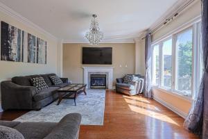 a living room with a couch and a fireplace at Harmony House in Richmond Hill
