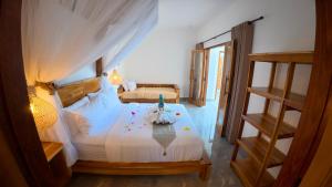 a bedroom with a bed with a white bedspread at Ajolie Villa in Gili Islands +67 photos