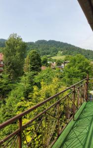 a wooden bridge with a view of a forest at APARTAMENT U MARYSI in Krościenko