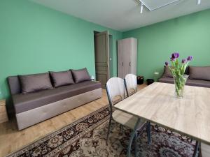 a living room with a table and a couch at Levendula Vendégház - Bezi in Bezi