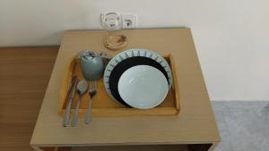 a tray with a plate and utensils on a table at Datang Kemari Bungalow in Gili Islands