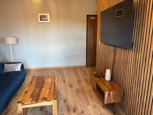 a living room with a blue couch and a table at Apartament Nova Starówka 2 in Konin