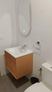 a bathroom with a sink and a mirror and a toilet at Casa Rochafrida in Ossa de Montiel +30 photos