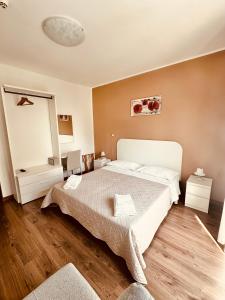 a bedroom with a large bed and a mirror at Hotel Playa in Bibione